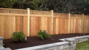 Brand new wood fence with simple landscaping. 