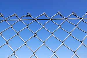 Chain link fence with a blue sky in the background